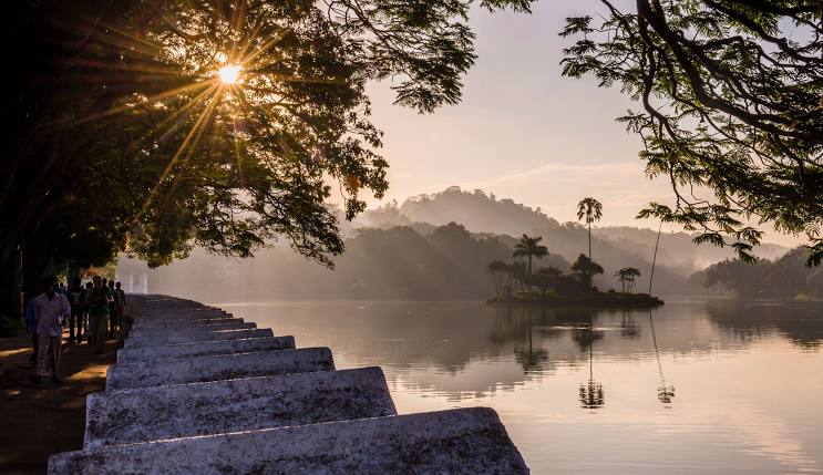 Serene Kandy Lake with surrounding green hills and city architecture